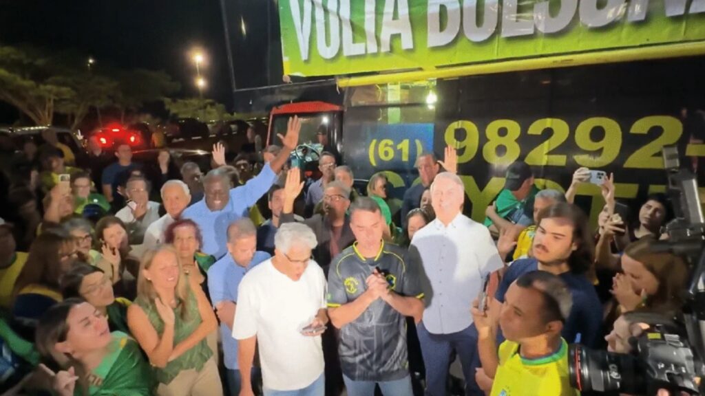 As imagens da vigília promovida no sábado (22) pelo senador Flávio Bolsonaro (PL-RJ), em Brasília, mostram um boneco do ex-presidente Jair Bolsonaro e, atrás deles e dos apoiadores, o carro de um trio elétrico